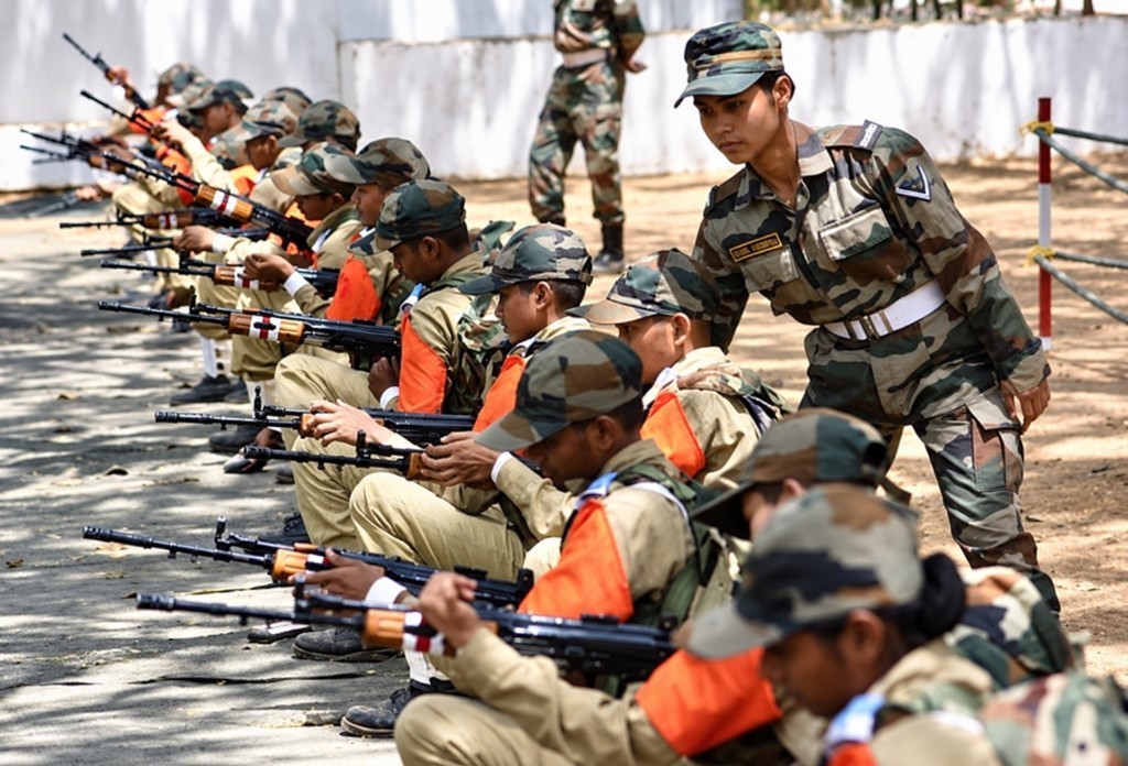 Soldiers in combat dress train on a firing range.