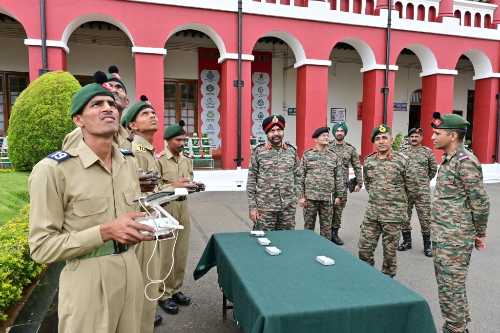 Soldiers in uniform train with a drone controller.